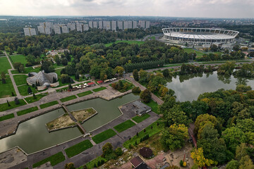 Aerial panorama of stadium planetarium observatory and water features in urban forest landscape Silesian Park Katowice Chorzow Poland modern architecture scenic tourism infrastructure
