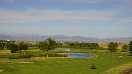 lush green golfcourse, overlooking Colorado mountains