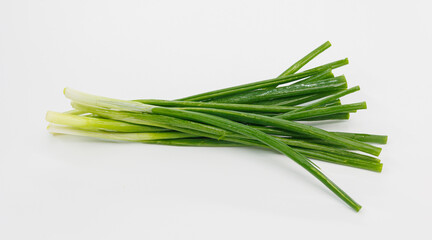 Fototapeta premium A bright bundle of green onions laid on a clean white background. Perfect for cooking, garnishes, salads, or healthy meal ideas and recipe visuals.