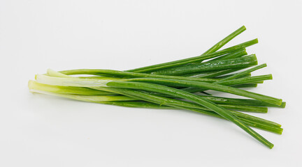 Fototapeta premium A bright bundle of green onions laid on a clean white background. Perfect for cooking, garnishes, salads, or healthy meal ideas and recipe visuals.
