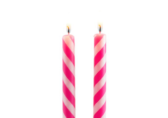 Two pink striped birthday candles isolated PNG on transparent background, festive celebration...