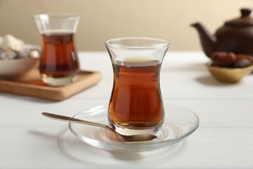 Traditional Turkish tea in glasses on white wooden table, closeup