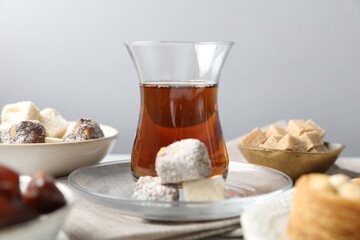 Traditional Turkish tea served with sweets on table, closeup