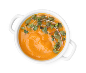 Delicious pumpkin soup with seeds and microgreens in bowl isolated on white, top view