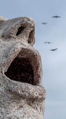 Stone sentinel gazes skyward as migratory whispers echo ancient legends, embodying Obon spirit and International Day of Peace