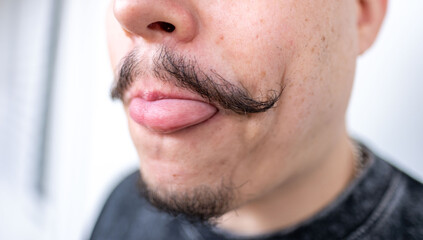 middle-aged man playfully sticking tongue, elegant, well-groomed mustache and serious expression, Authentic male portrait confidence, mature masculinity, self confident, Gentlemanly style male face