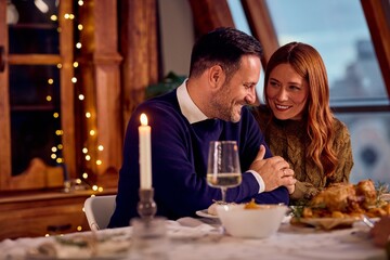 Romantic Couple Dining Together By Candlelight During New Year Celebration At Cozy Dinner Table
