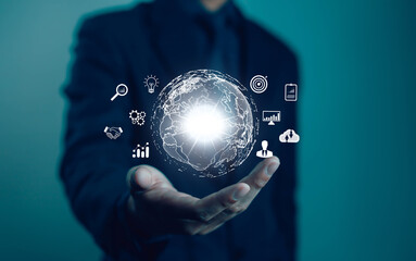 A businessman holds a digital globe with data connection network icons. Developing the evolving intelligence and global business development, applying digital technology and artificial intelligence.