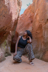A woman is posing in a cave with her legs crossed