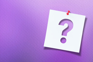White note paper with question mark and red push pin on textured purple  background