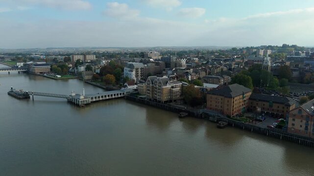 Aerial drone view of Gravesend town on the River Thames in Foggy conditions late sunset opposite Tilbury, pier and buildings, London, United Kingdom