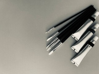 Black and white.Set of painting supplies including paint tubes, brushes ,Perfect for art, creativity, and design concepts.