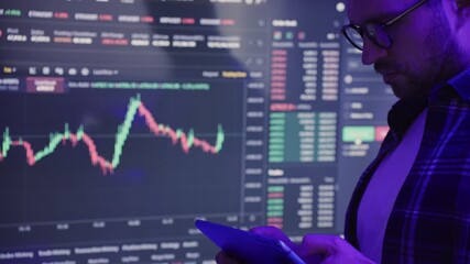 Businessman checking stock market data while using digital tablet. Slow motion - Powered by Adobe