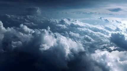 Aerial view of dramatic clouds casting shadows over a deep blue ocean at twilight