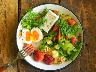 Healthy Breakfast or Brunch Salad with Feta Cheese, Soft-Boiled Egg, and Fresh Strawberries