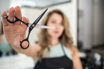 Woman holding scissors. Woman hairdresser