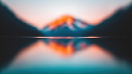 A serene landscape featuring a blurred mountain and reflective water, illuminated by soft colors of dawn or dusk.