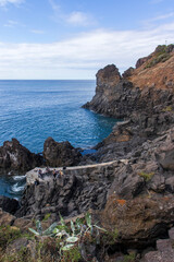 The Poças do Governador in Madeira are natural volcanic pools near São Vicente, where dark rocks meet crystal-clear Atlantic waters, creating a peaceful spot for swimming and relaxation.