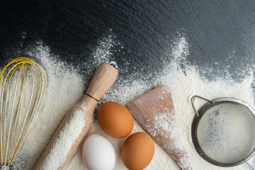 Baking utensils laying on flour background flat lay view with copyspace