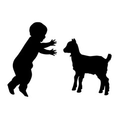 Child reaching for young goat silhouette baby