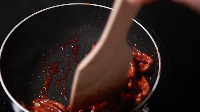 pecan nuts caramelizing in a pan