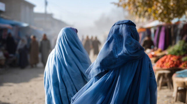 Afghan women wearing traditional blue burkas walking through a local market in Andkhoy, Faryab Province, Northern Afghanistan vibrant bazaar with colorful fabrics, fruits, and spic