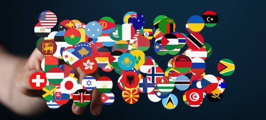 Fototapeta premium A hand holding a cluster of international flags, symbolizing global unity, cooperation, and the concept of a connected world. Perfect for themes