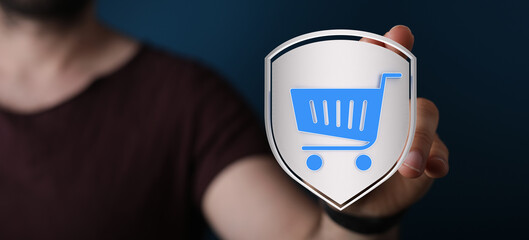 Concept of secure online shopping and e-commerce with a shield featuring a shopping cart icon. Represents protection and confidence in purchasin