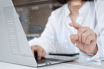 Businesswoman using laptop with digital Gantt chart interface for project management, planning, scheduling, workflow optimization, teamwork efficiency, and corporate productivity improvement.