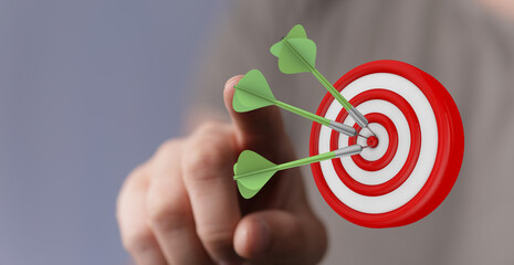 Hand pointing at a bullseye with darts, symbolizing achievement, focus, and strategic planning....