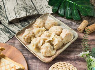 Homemade Steamed corn dumplings, beautifully arranged on a rustic wooden table. Evokes warmth and culinary delight, ideal for food blogs or restaurant promotions.