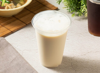 Creamy cup of soy milk, perfect for a healthy and delicious snack. A tasty beverage to complement your meal.