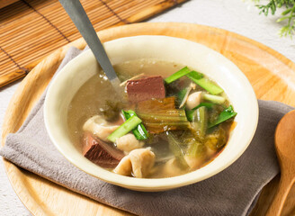 Taiwanese pork blood soup with Large Intestine, vibrant greens, a healthy and flavorful choice. Perfect for food blogs, restaurants, or culinary adventures. Taste the tradition!