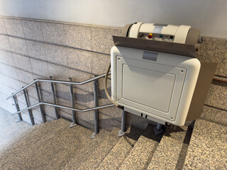 automatic lift for people with disabilities on the stairs in the front entrance of a residential building