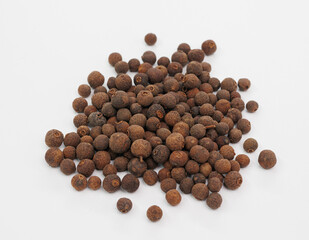 Pile Of Brown Allspice Berries On White Background For Cooking, Spice, And Food Photography