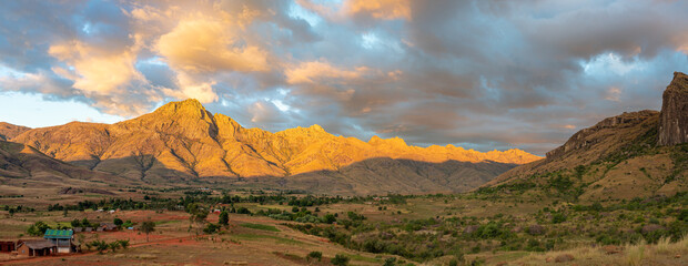 Golden light bathes rugged mountains at sunset