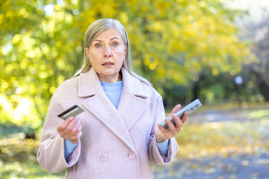 Senior woman experiencing online banking fraud scam - Powered by Adobe