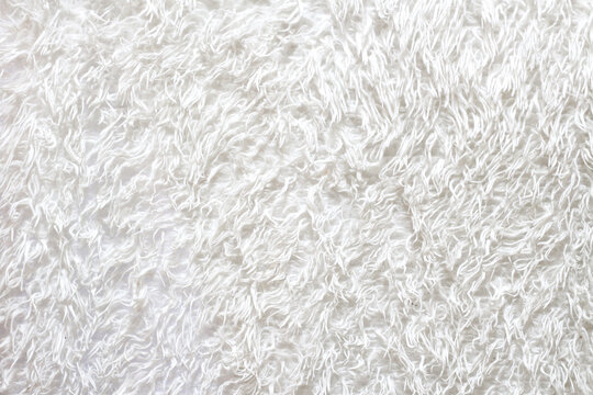 Fluffy white blanket, soft bedspread background.