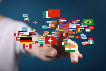 A hand points to a collection of international flags, symbolizing global connections, unity, and diverse cultures in a digital environment.