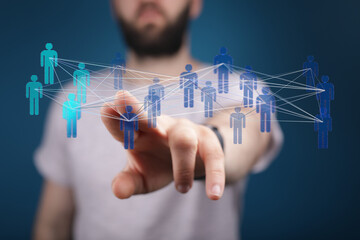 Close up shot of a hand interacting with a network of digital human figures connected by lines. Concept of teamwork, social media, and communica