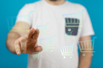 Hand reaching out to shopping cart icons, online shopping, purchasing digital product, choosing...