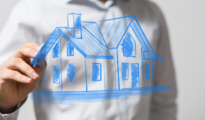 Image of a hand drawing a house plan. Ideal for real estate, architecture, and home design concepts.