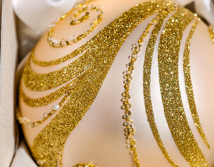 Elegant Ivory Christmas Bauble with Gold Glitter Swirls and Crystal Beads - Macro for Luxury Holiday Decor and Festive Designs