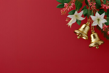 Christmas bells with Christmas flowers as a background. Christmas festive background 