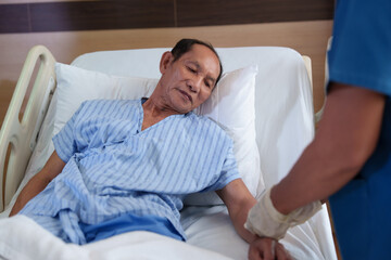 A doctor or nurse is caring for a patient with respiratory problems. A portable oxygen concentrator or other type of oxygen generator.