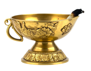 Ornate gold bowl with handle, detailed relief, containing burnt stick, lit against white