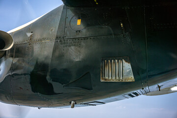 Airplane Engine Detail with “Check Oil Filled Cap Closed” Text. Macro shot of airplane engine surface. Close-up view showing metallic texture and industrial details of aviation engineering.
