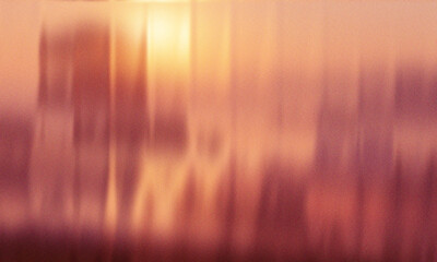Naklejka premium Abstract vertical streaks of warm orange and pink light with bokeh background
