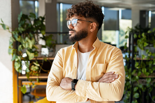 Thoughtful young man contemplating business success - Powered by Adobe