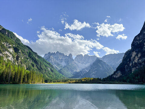 Aerial drone view of Lago di Landro known as D&uuml;rrensee lake. Lago di Landro in Dolomites, green alpine lake and trees along the mountain road.Dolomites mountains, Italy.